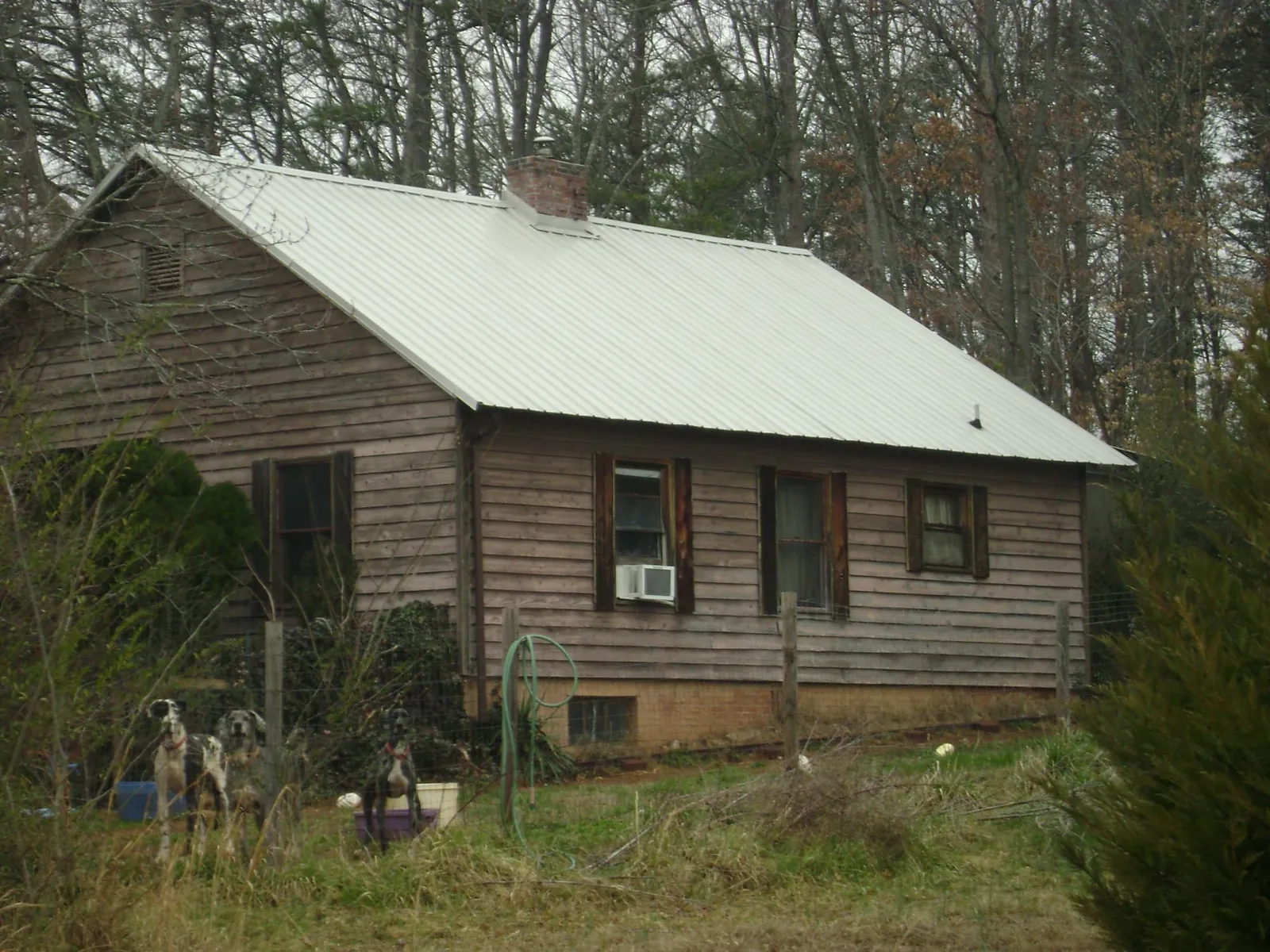 White metal roof on an old wood sided farmhouse, from a Metal Roof Installation job in Kirtland Afb